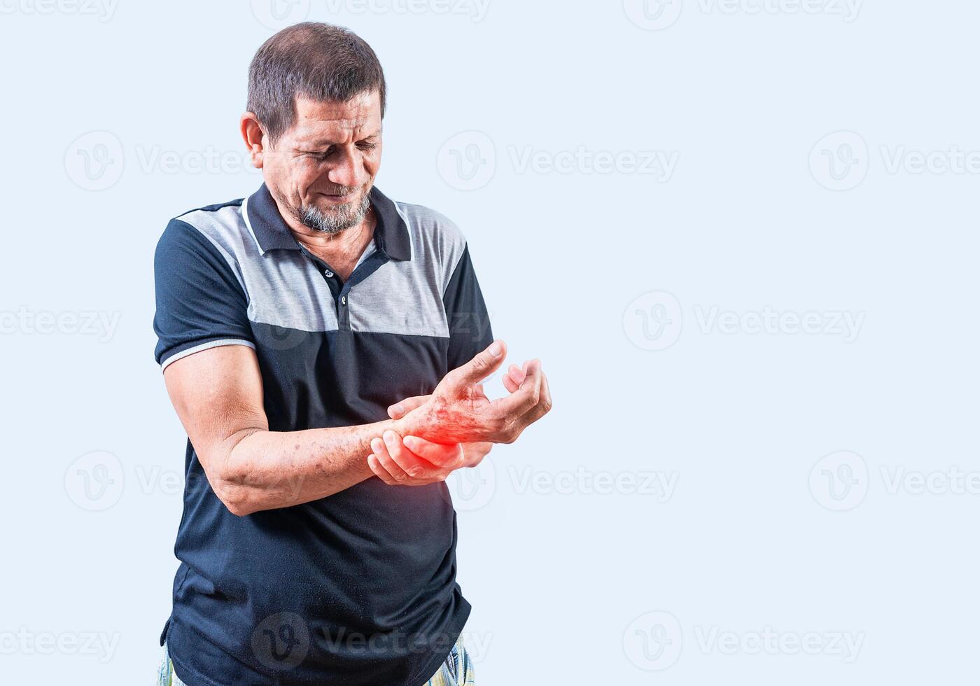 Senior man with arthritis in hands isolated. Elderly people with arthritis and hand pain photo