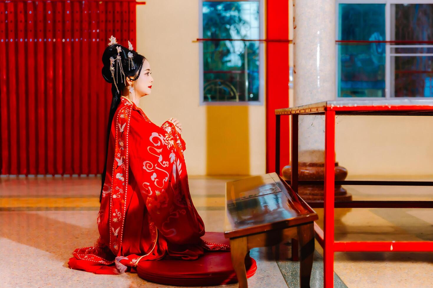Woman dress China New year. portrait of a woman. person in traditional costume. woman in traditional costume. Beautiful young woman in a bright red dress and a crown of Chinese Queen posing. photo