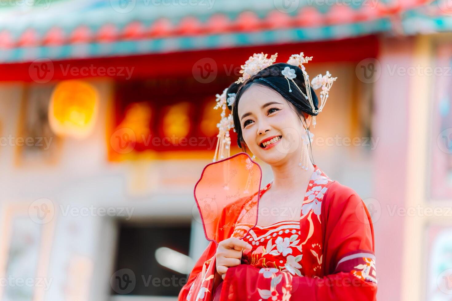 Woman dress China New year. portrait of a woman. person in traditional costume. woman in traditional costume. Beautiful young woman in a bright red dress and a crown of Chinese Queen posing. photo