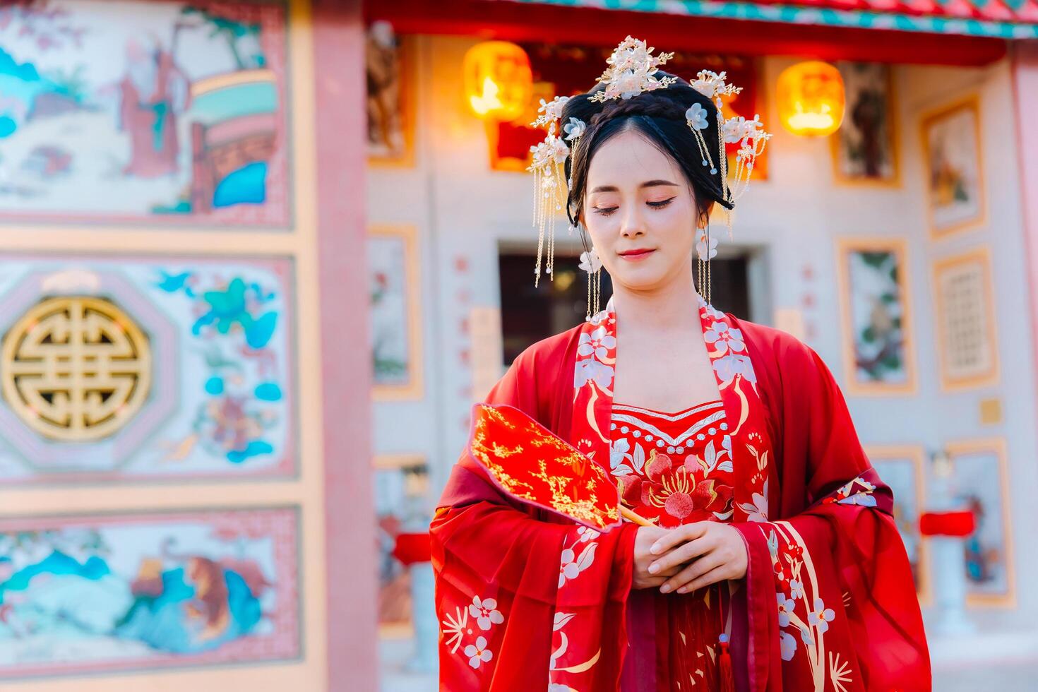 Woman dress China New year. portrait of a woman. person in traditional costume. woman in traditional costume. Beautiful young woman in a bright red dress and a crown of Chinese Queen posing. photo