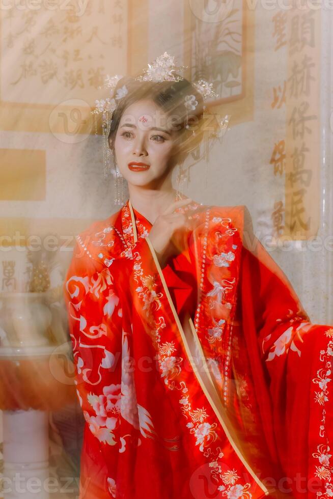 Woman dress China New year. portrait of a woman. person in traditional costume. woman in traditional costume. Beautiful young woman in a bright red dress and a crown of Chinese Queen posing. photo