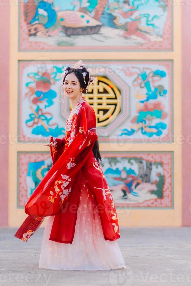 Woman dress China New year. portrait of a woman. person in traditional costume. woman in traditional costume. Beautiful young woman in a bright red dress and a crown of Chinese Queen posing. photo