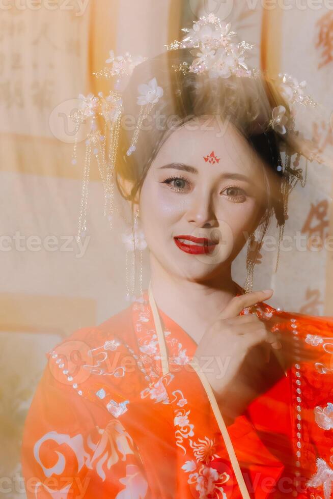 Woman dress China New year. portrait of a woman. person in traditional costume. woman in traditional costume. Beautiful young woman in a bright red dress and a crown of Chinese Queen posing. photo