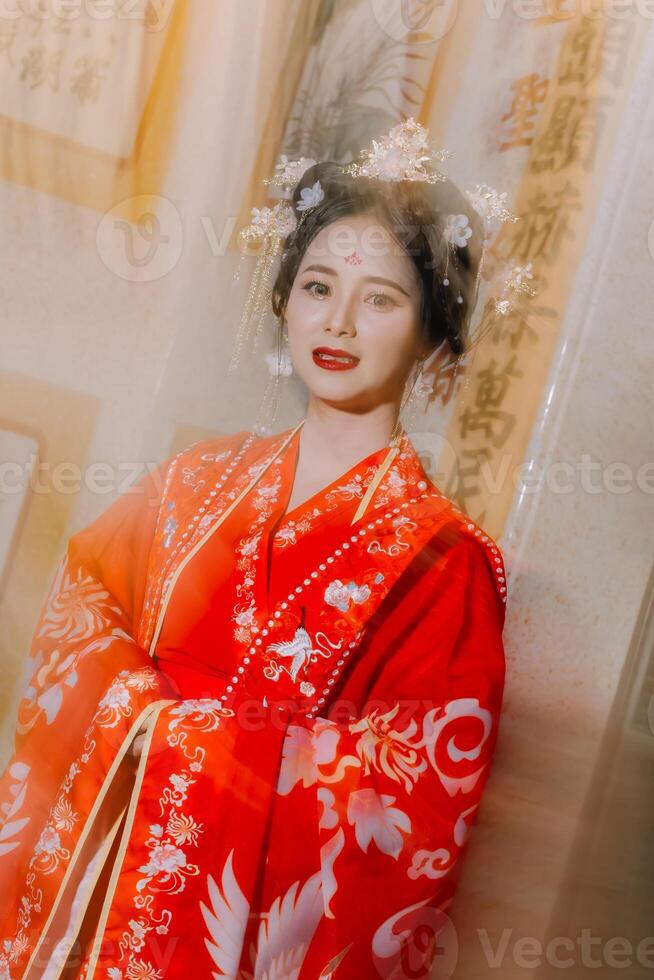 Woman dress China New year. portrait of a woman. person in traditional costume. woman in traditional costume. Beautiful young woman in a bright red dress and a crown of Chinese Queen posing. photo