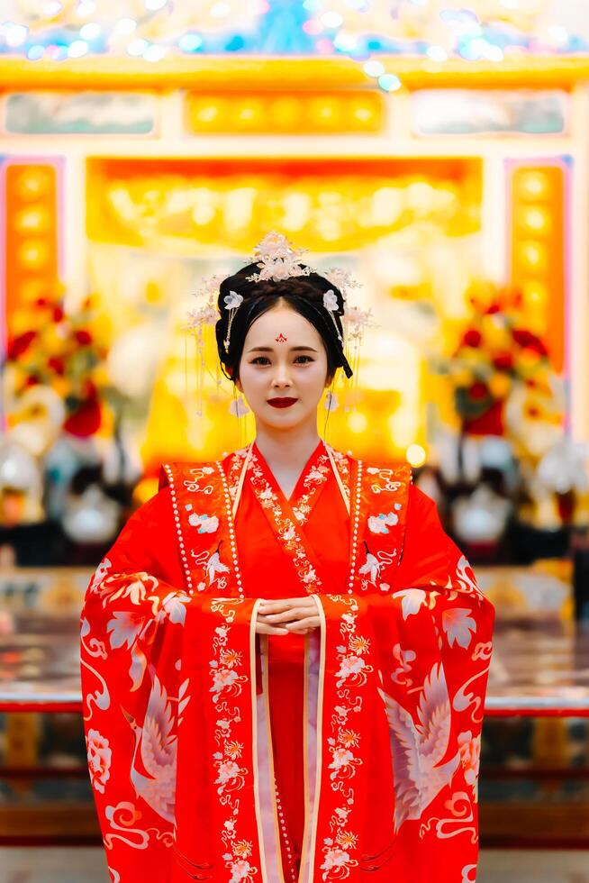 Woman dress China New year. portrait of a woman. person in traditional costume. woman in traditional costume. Beautiful young woman in a bright red dress and a crown of Chinese Queen posing. photo