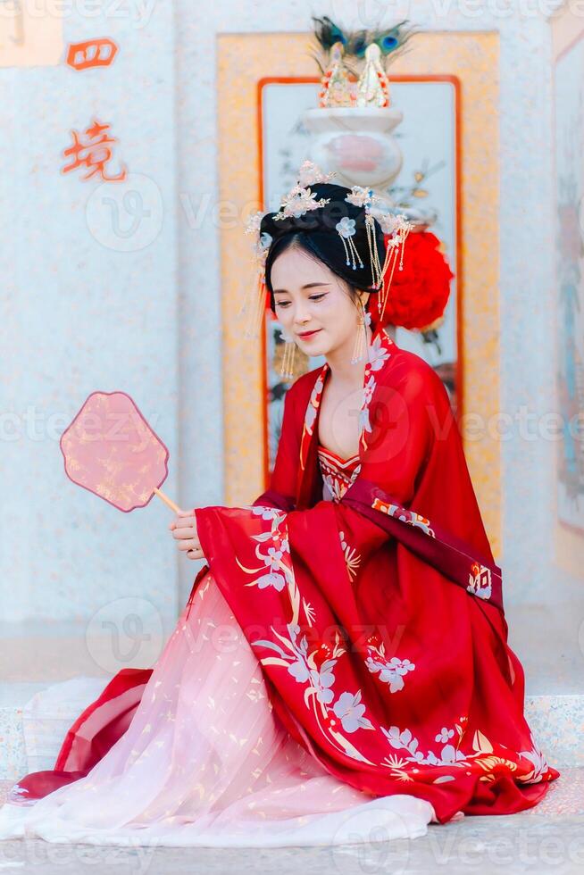 Woman dress China New year. portrait of a woman. person in traditional costume. woman in traditional costume. Beautiful young woman in a bright red dress and a crown of Chinese Queen posing. photo