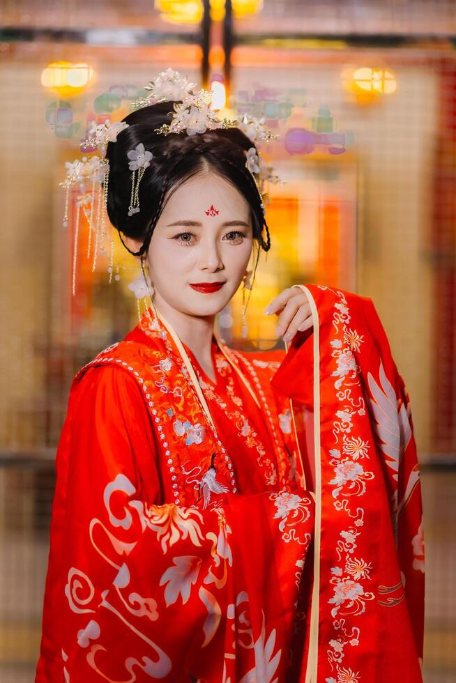 Woman dress China New year. portrait of a woman. person in traditional costume. woman in traditional costume. Beautiful young woman in a bright red dress and a crown of Chinese Queen posing. photo