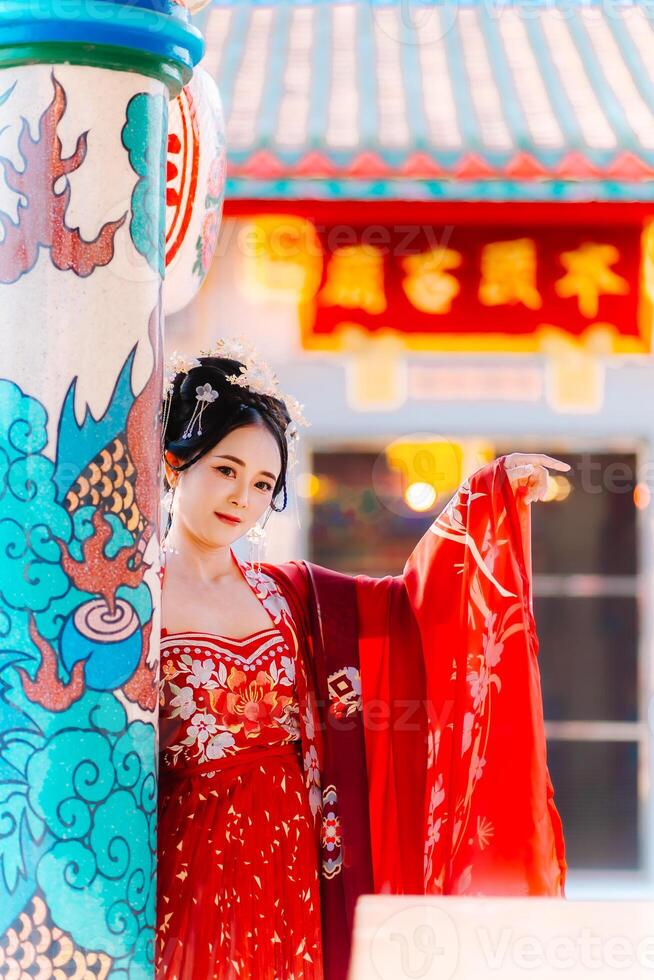 Woman dress China New year. portrait of a woman. person in traditional costume. woman in traditional costume. Beautiful young woman in a bright red dress and a crown of Chinese Queen posing. photo