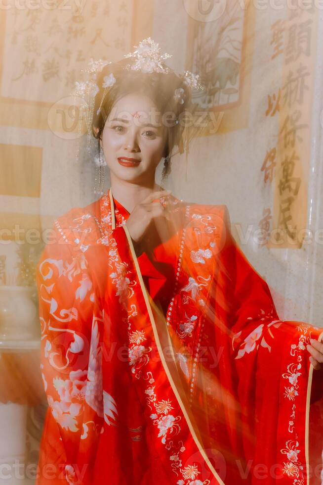 Woman dress China New year. portrait of a woman. person in traditional costume. woman in traditional costume. Beautiful young woman in a bright red dress and a crown of Chinese Queen posing. photo