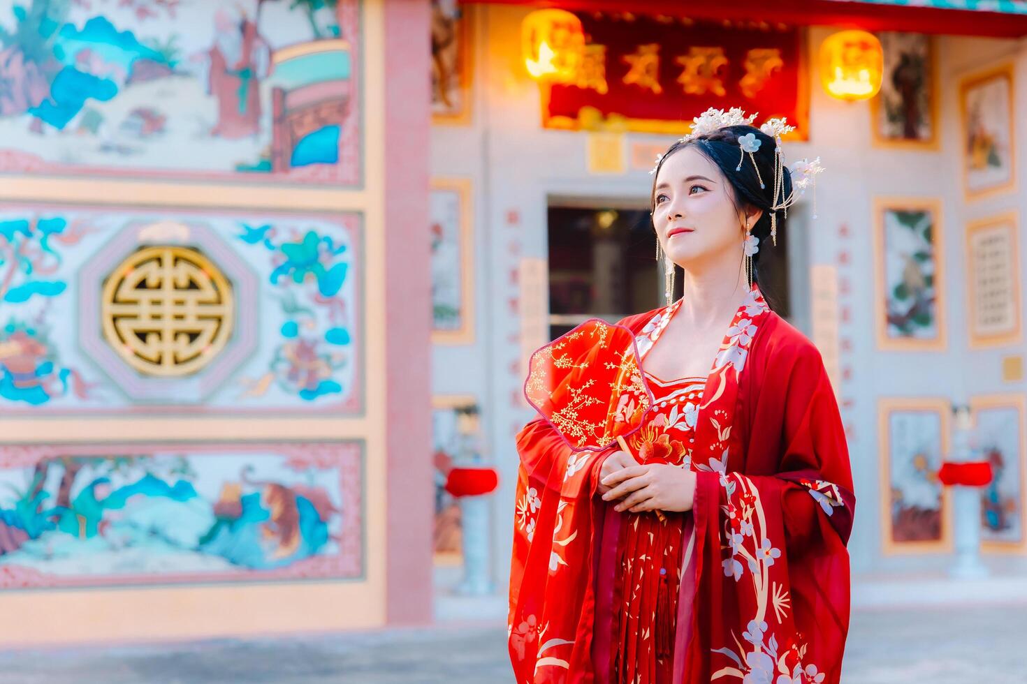 Woman dress China New year. portrait of a woman. person in traditional costume. woman in traditional costume. Beautiful young woman in a bright red dress and a crown of Chinese Queen posing. photo