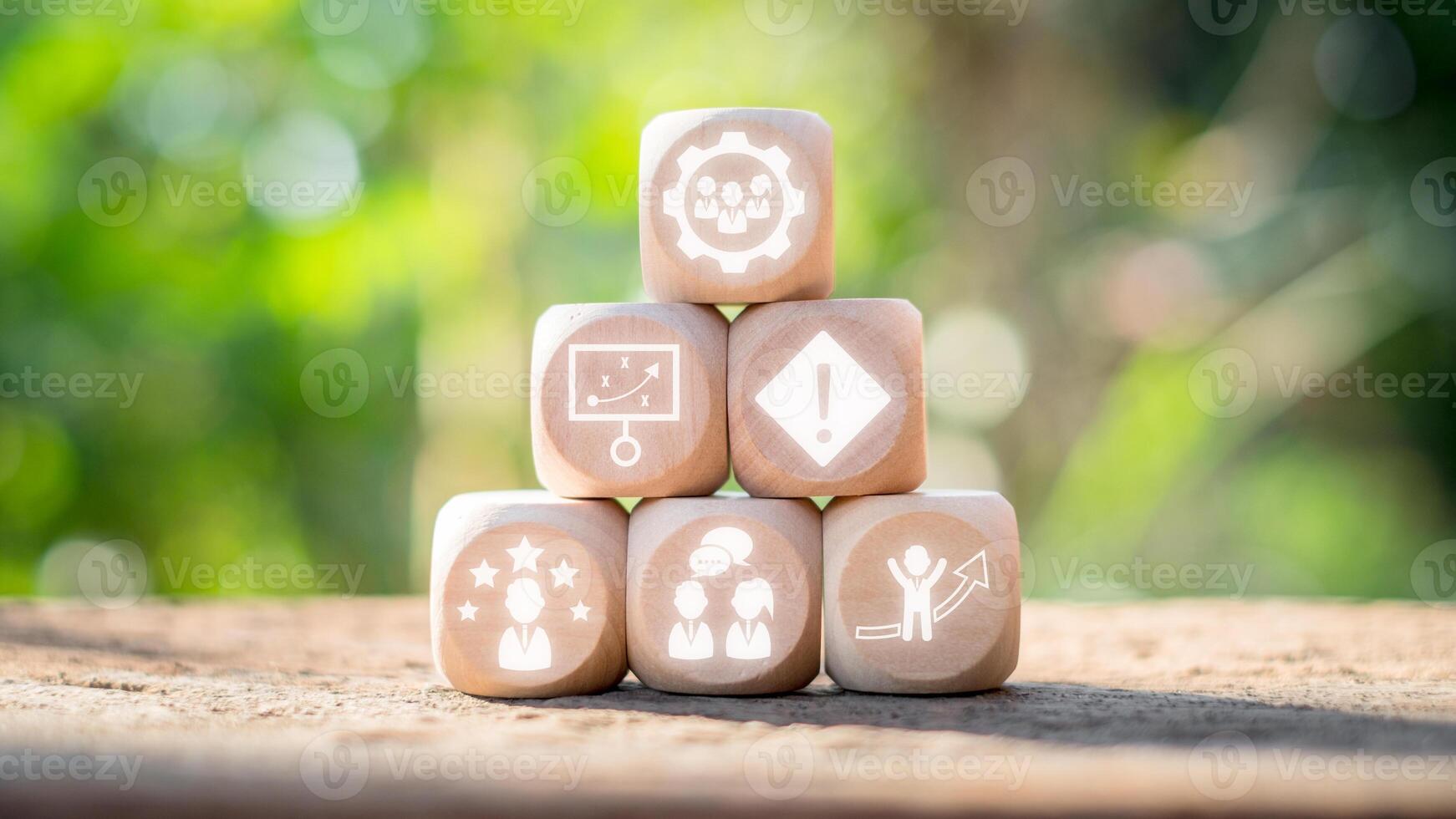 Team building concept, Wooden block on desk with team building icon on virtual screen. Team Spirit, Motivation, Training, Competency, Collaboration, Communication, Goal, Social Relations. photo