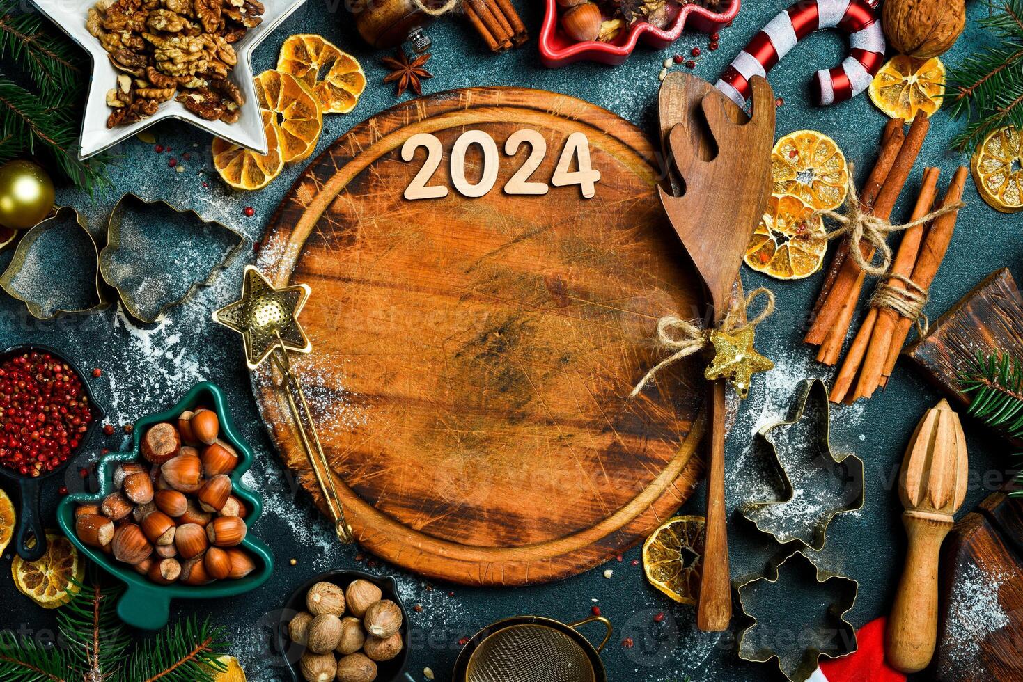 Christmas baking background. Kitchen cutting board and baking ingredients. Christmas and New Year food. Top view of kitchen table. photo