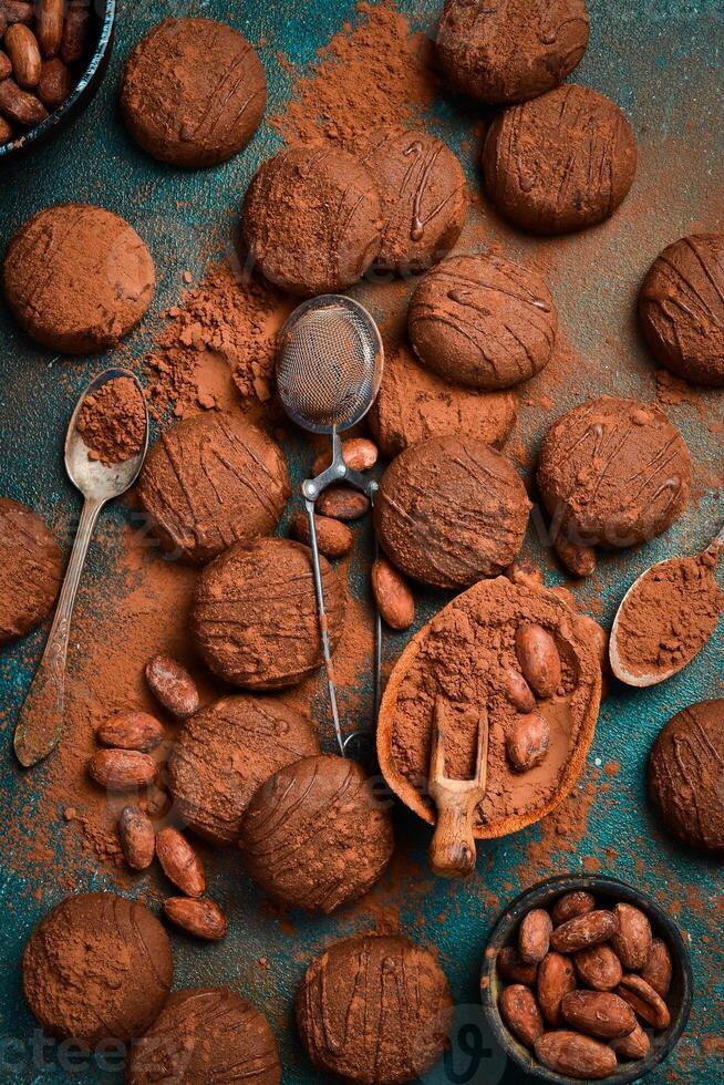 Chocolate brown cookies with cocoa beans. Side view. On a dark background. photo