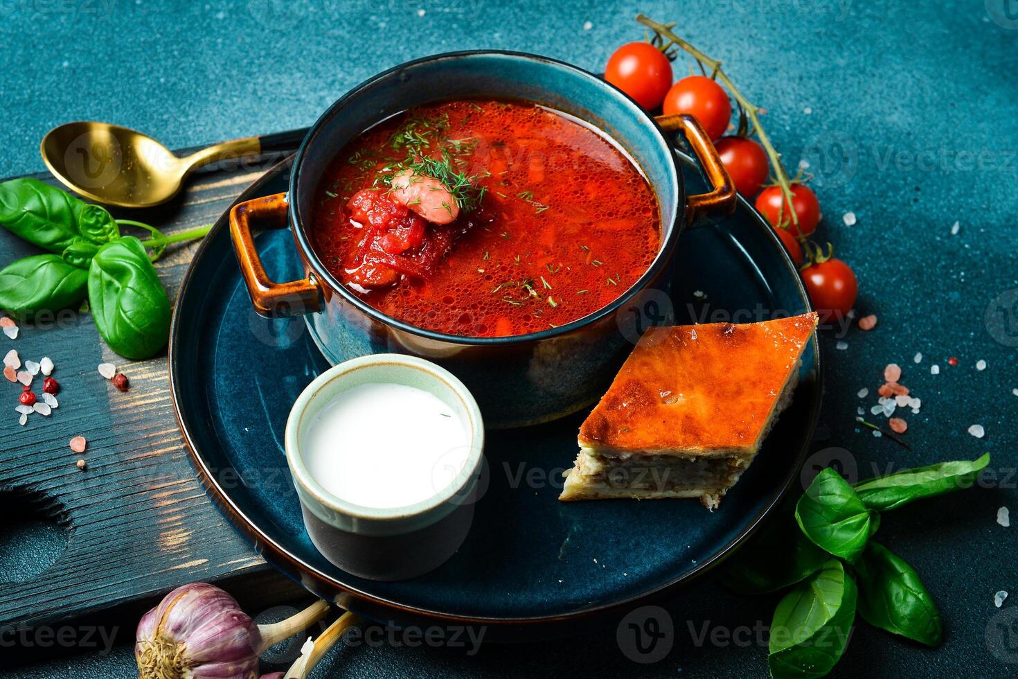 Homemade borsch with sour cream. Beet soup. Ukrainian cuisine. Close up. On a dark stone background. photo