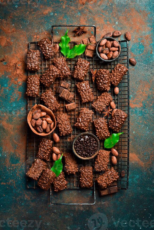Chocolate cookies with dark chocolate and nuts. Dessert. Top view. On a dark background. Space for text. photo