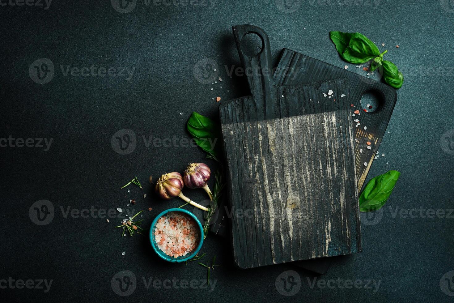 Kitchen vintage wooden cutting board. Brown board. Kitchen utensils. On a dark background. photo