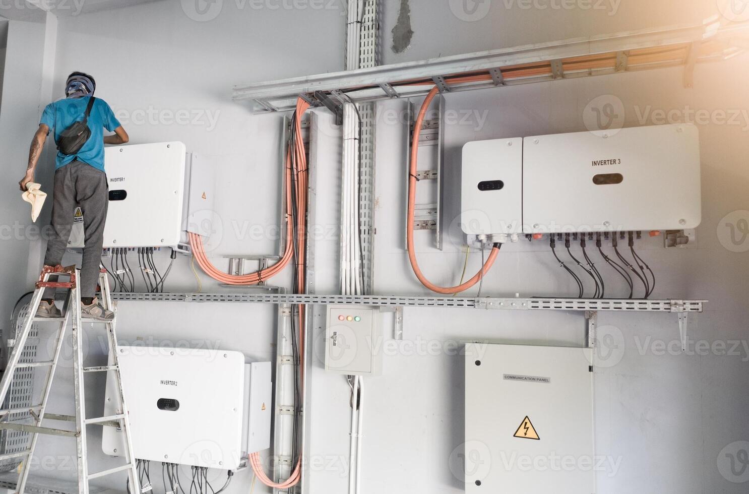 A technician is carrying out maintenance on a solar power inverter panel, the concept of regular maintenance on an inverter. photo