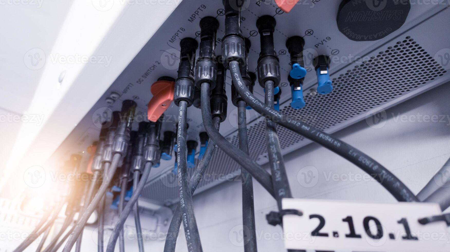 Cable connecting the power from the solar panel to the inverter with shiny light. Cable string connection on inverter control solar panel. Socket input supply voltage and Technology of solar energy. photo