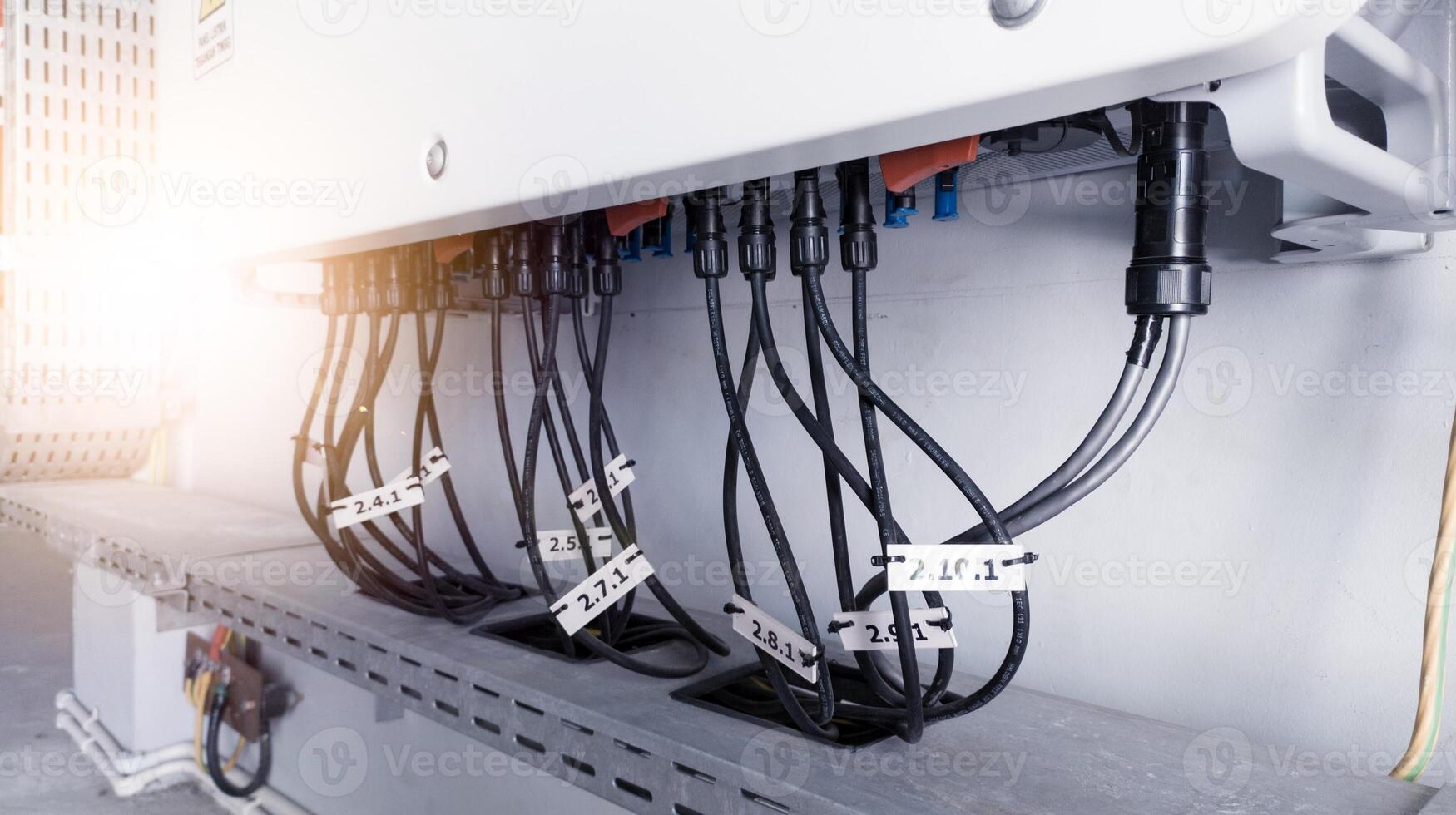 Cable connecting the power from the solar panel to the inverter with shiny light. Cable string connection on inverter control solar panel. Socket input supply voltage and Technology of solar energy. photo