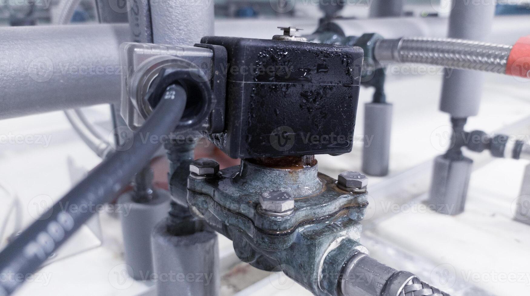 Installation Electrical Solenoid valve for Open and Closed Water cold flow  line to cooling pipe in machinery. photo