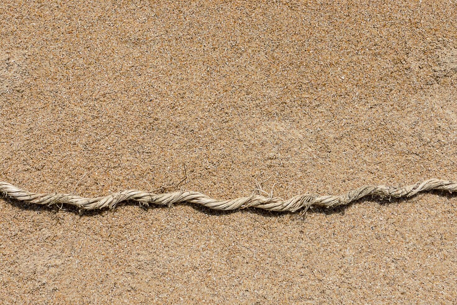 Old rope on the sand. photo
