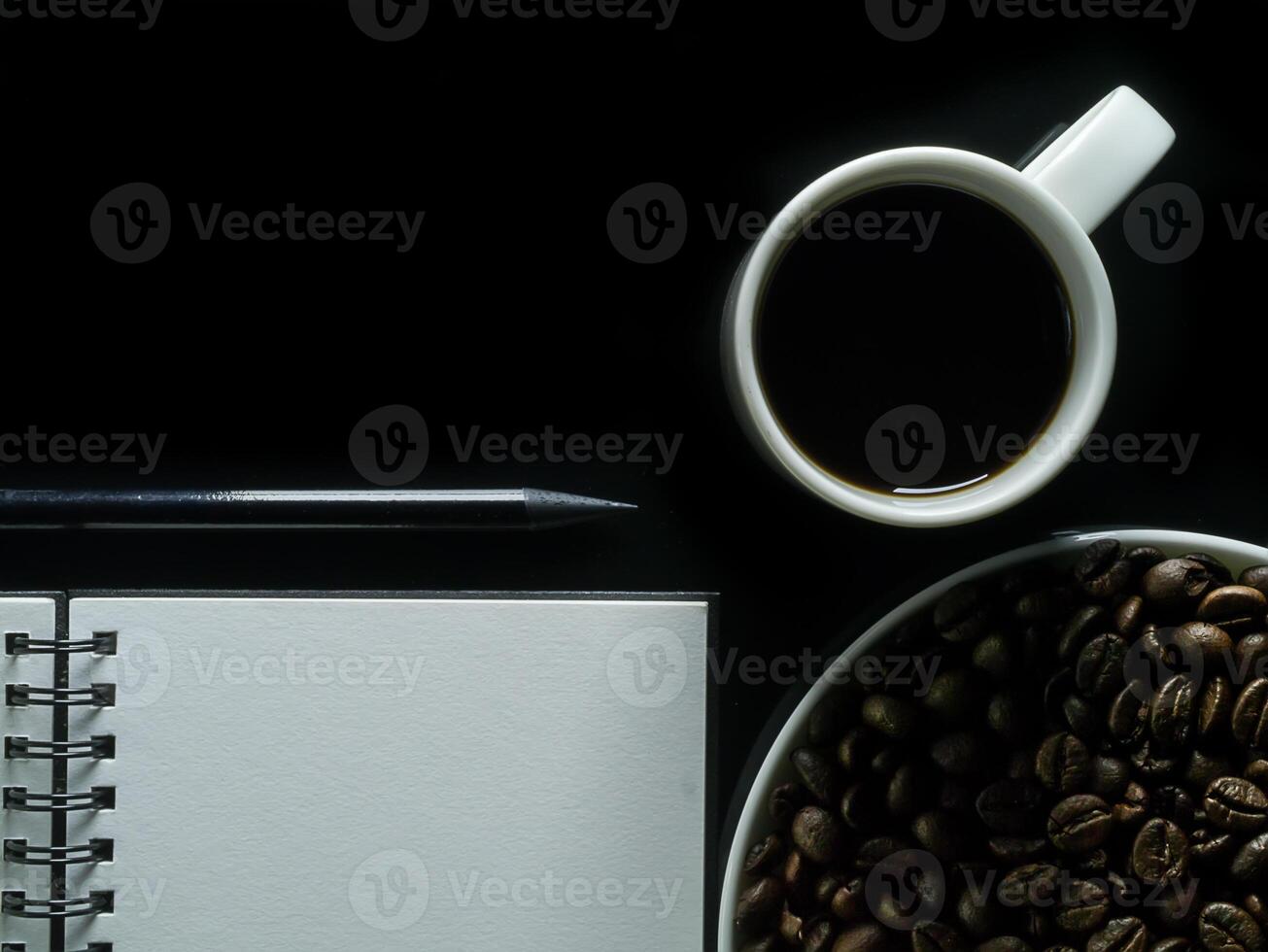 Close up blank page with coffee on black background. photo