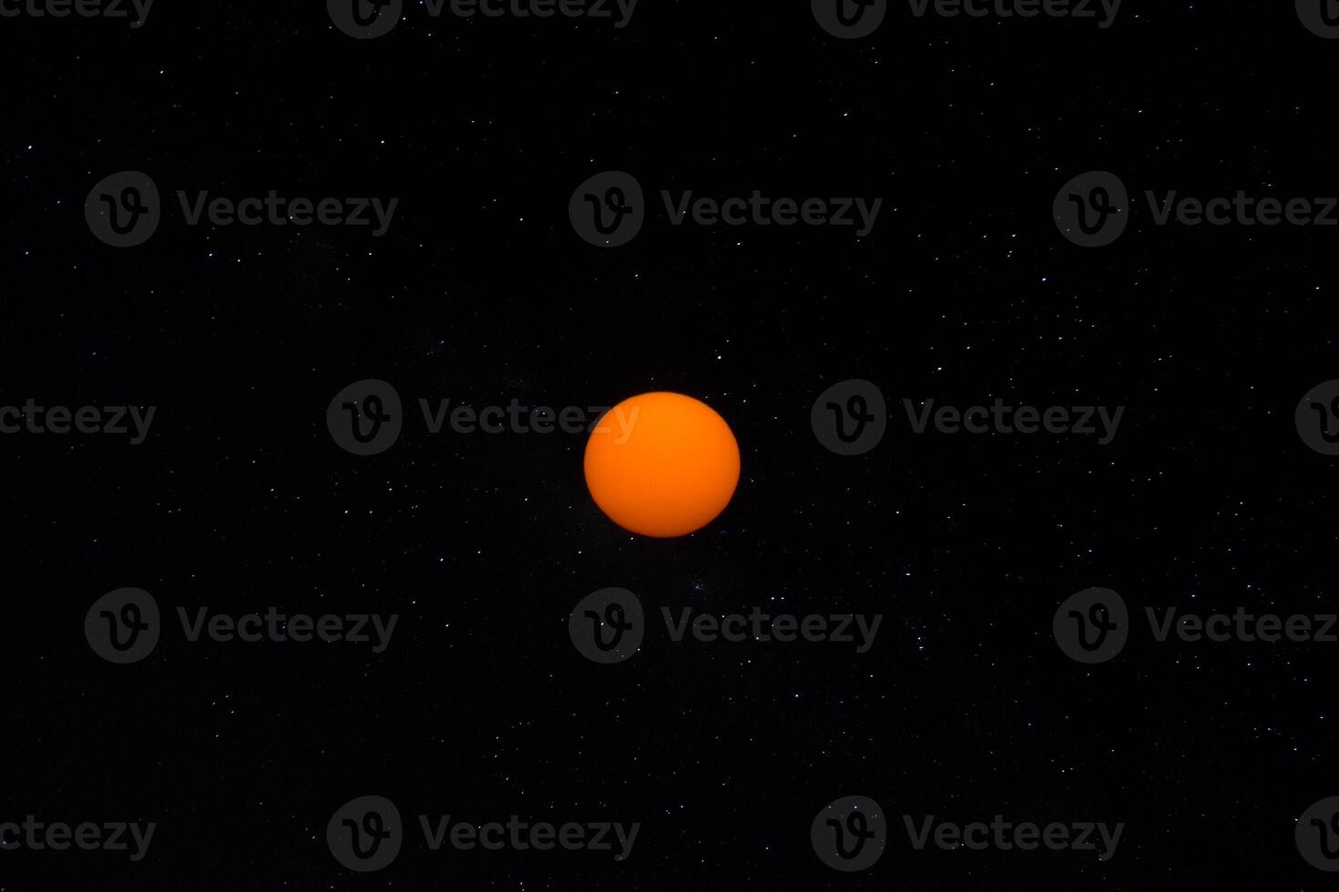 Orange sun in the dark sky. photo