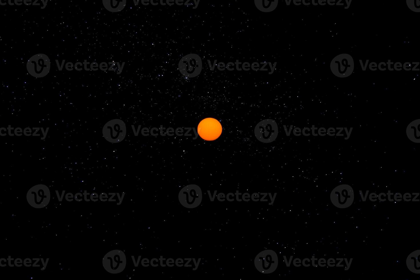 Orange sun in the dark sky. photo