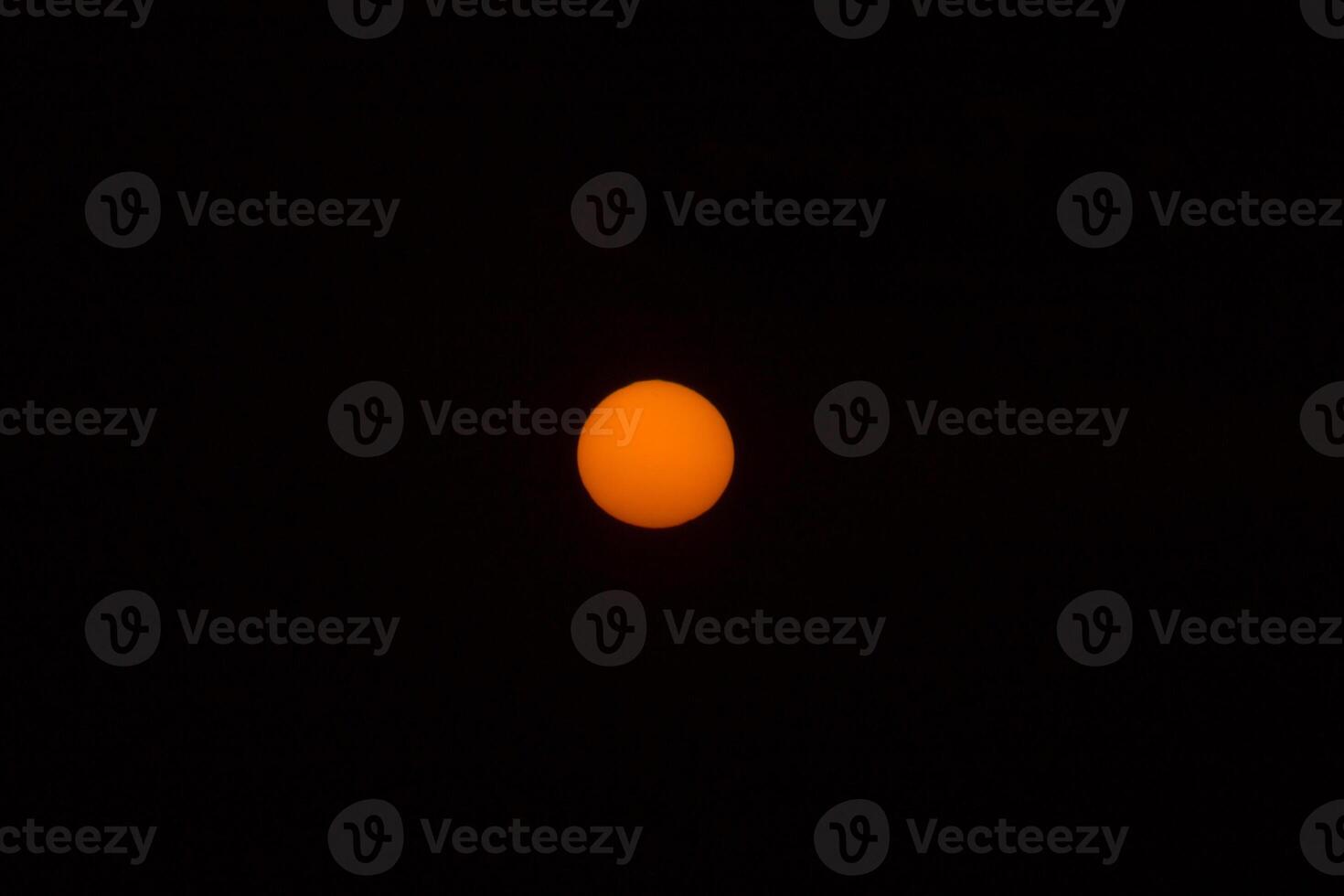 Orange sun in the dark sky. photo