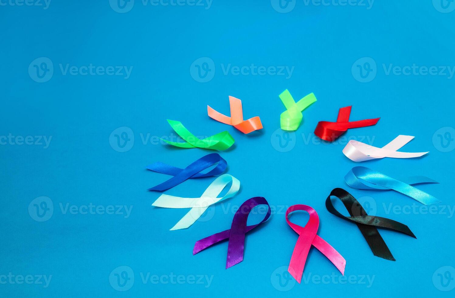 World cancer day February 4 background. Colorful ribbons, cancer awareness. blue surface from above photo