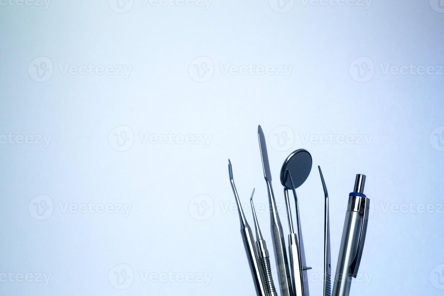 Dental instruments collection isolated on blue background photo