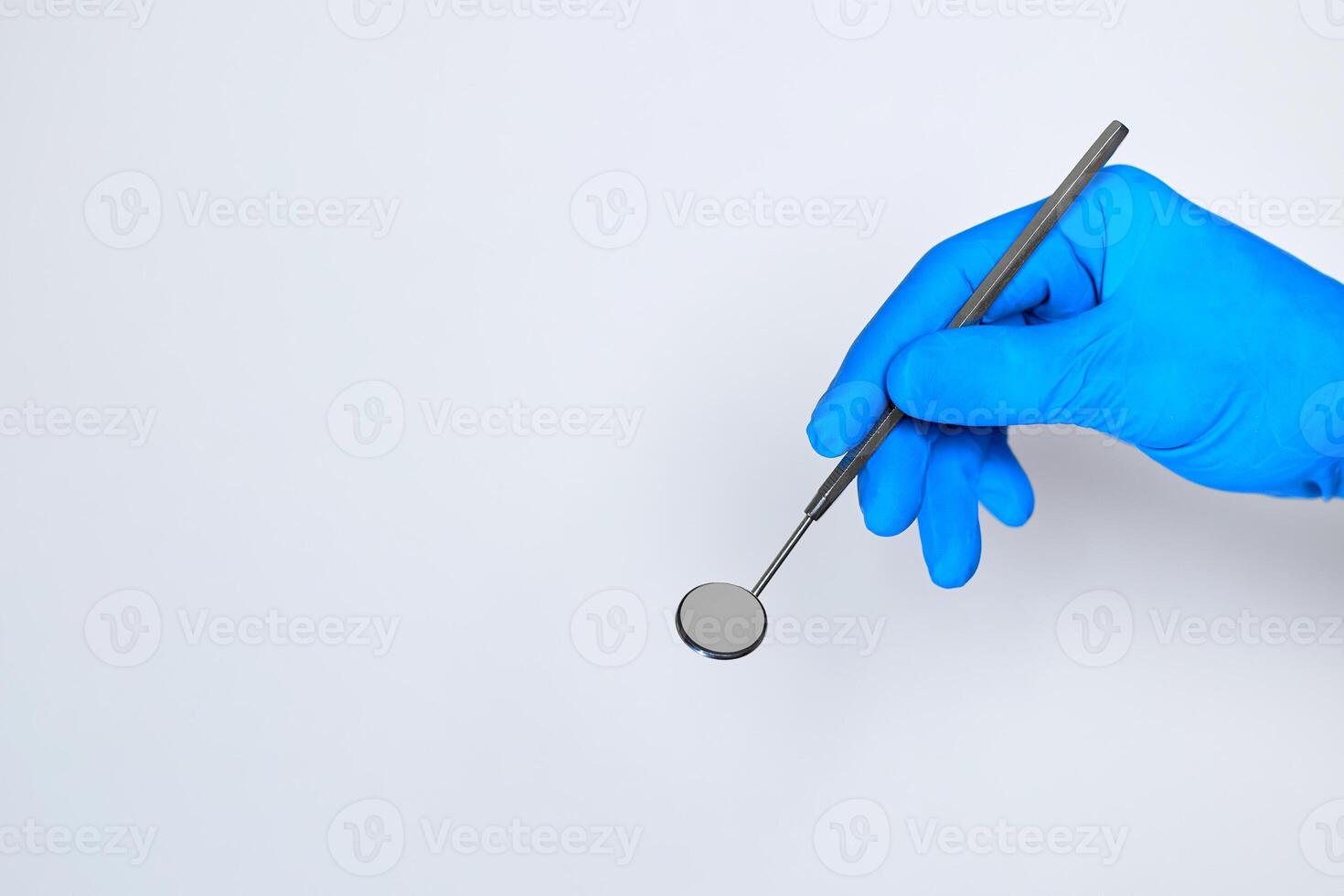 hand holding a dental tool isolated on white background. dental photo