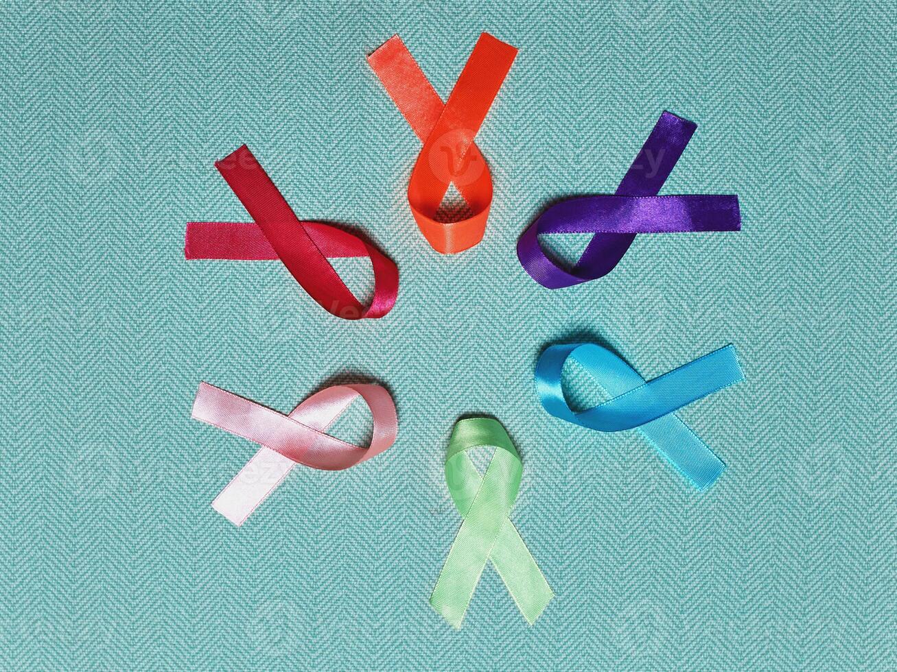 World Cancer Day. Colorful ribbons, cancer awareness, blue background. International Agency for Research on Cancer photo