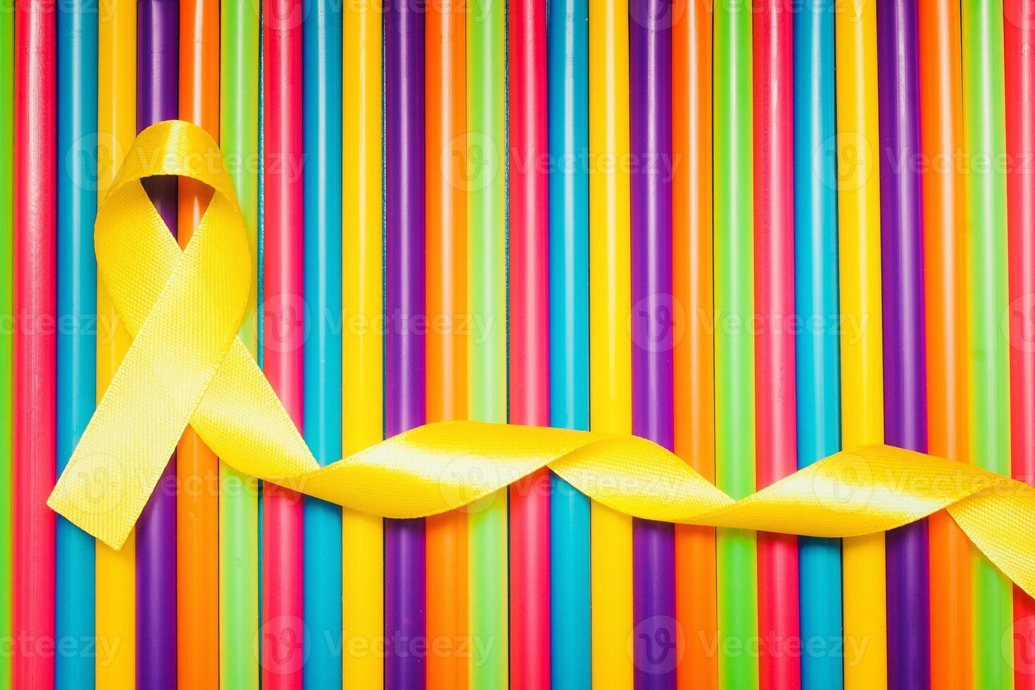 childhood cancer awareness day. Yellow ribbon on Colorful background. photo