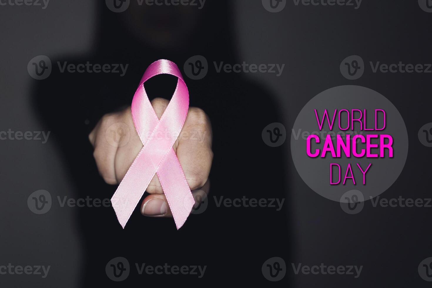 Pink ribbon for breast cancer awareness, symbolic bow color raising awareness on people living with women's breast tumor illness. With text WORLD CANCER DAY photo
