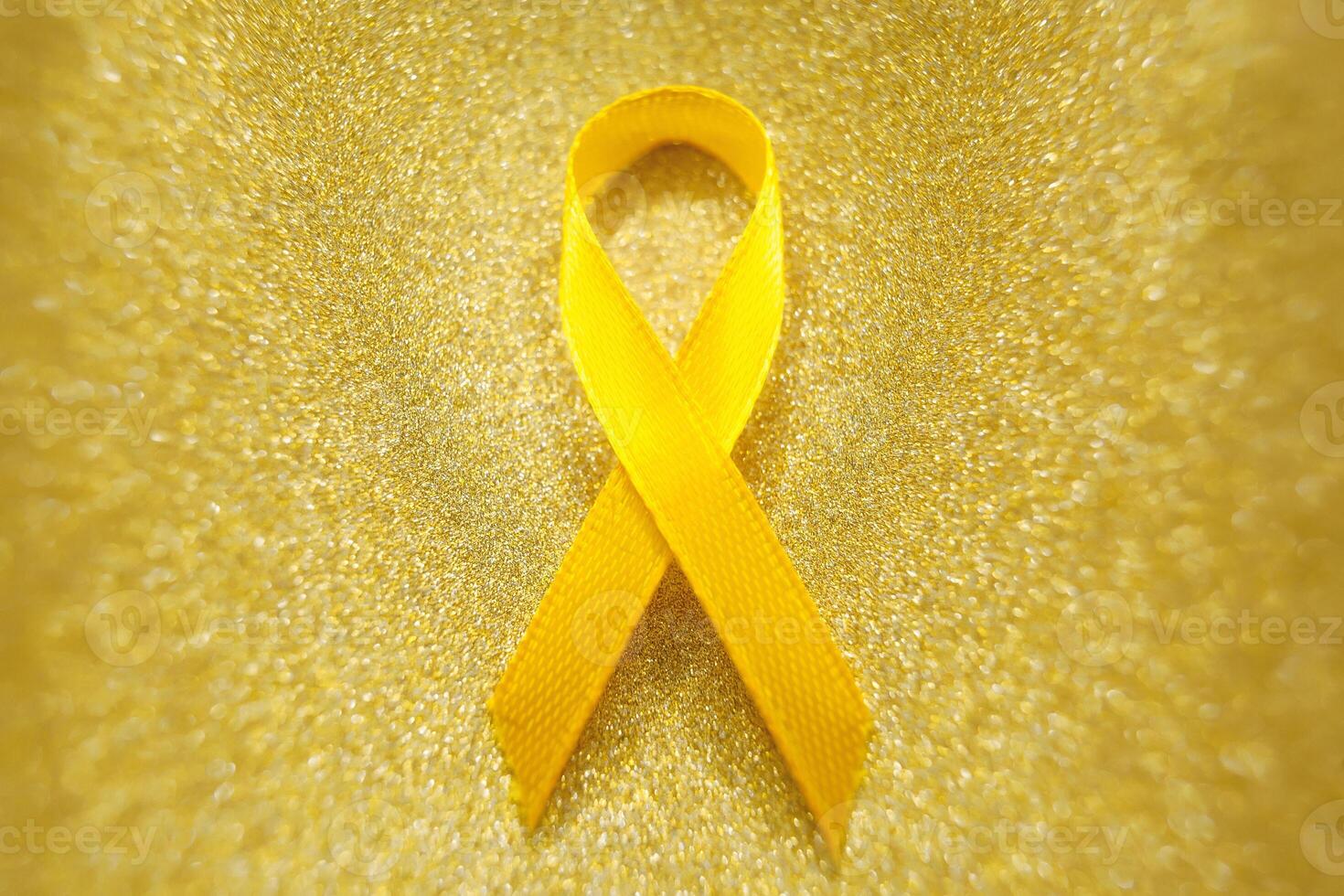 oro cinta para niños como un símbolo de infancia cáncer conciencia. mundo cáncer día foto