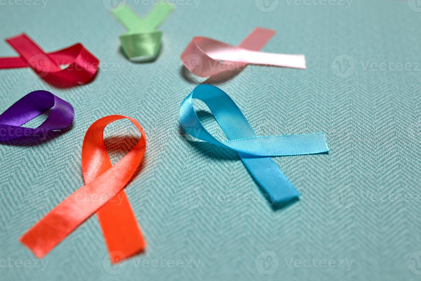 World Cancer Day. Colorful ribbons, cancer awareness, blue background. International Agency for Research on Cancer photo