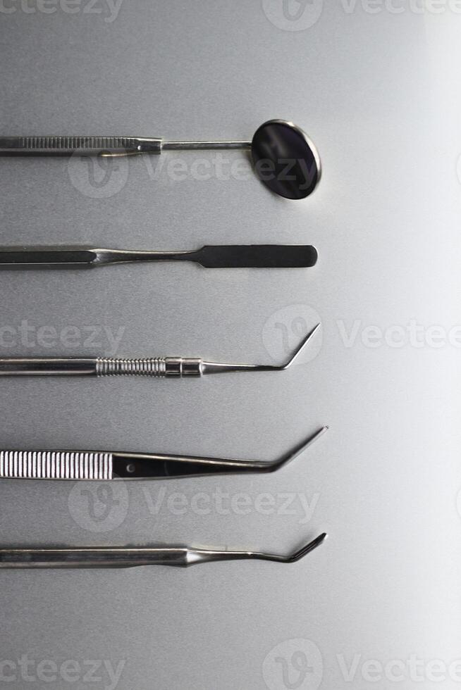 Dental tools on silver color background photo