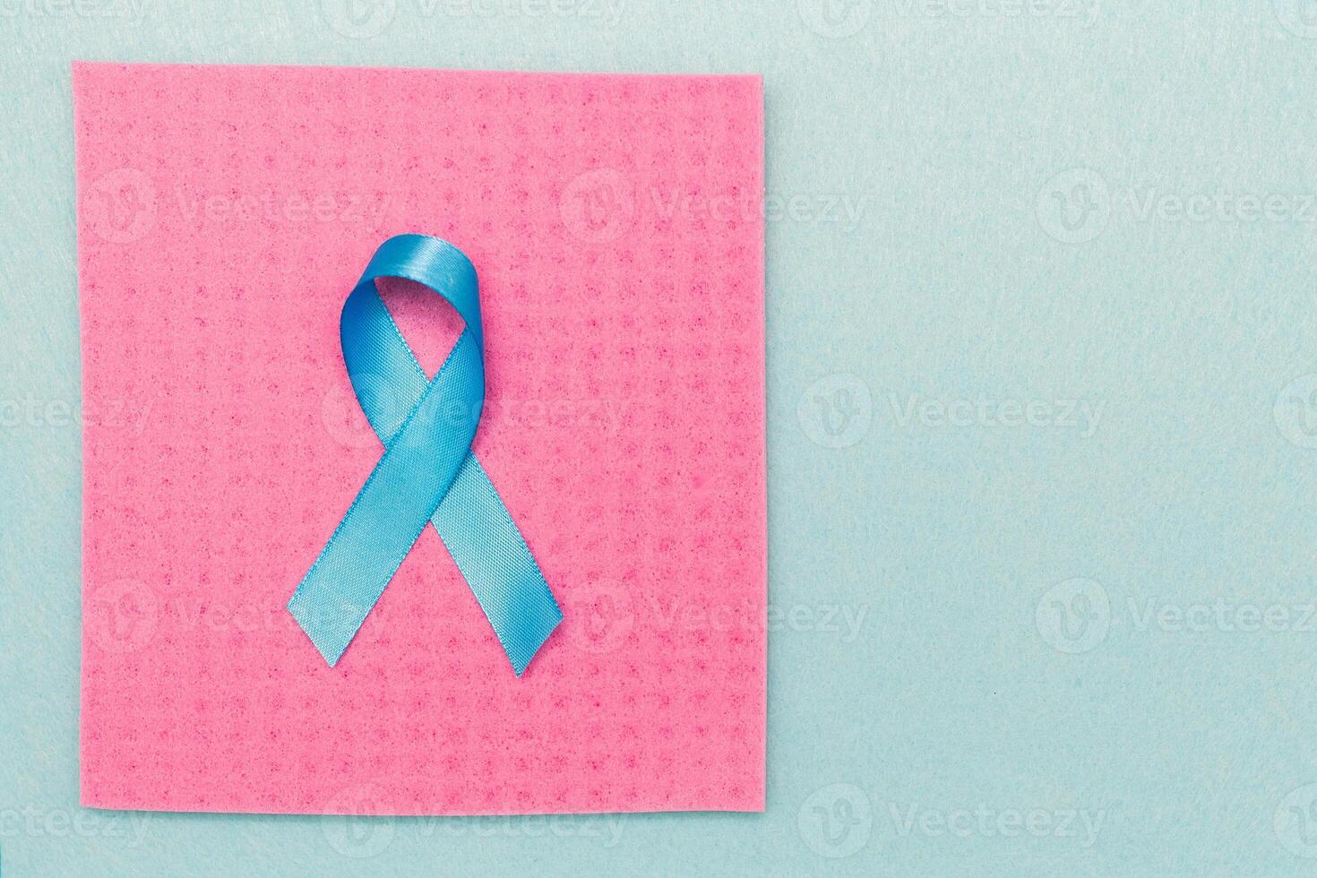 A blue ribbon in support of World Cancer Day, raising the awareness of people living with a prostate tumor. photo