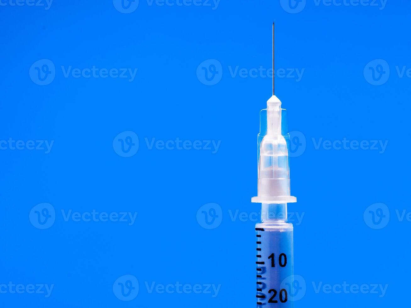 Insulin syringe closeup on blue background. diabetes photo