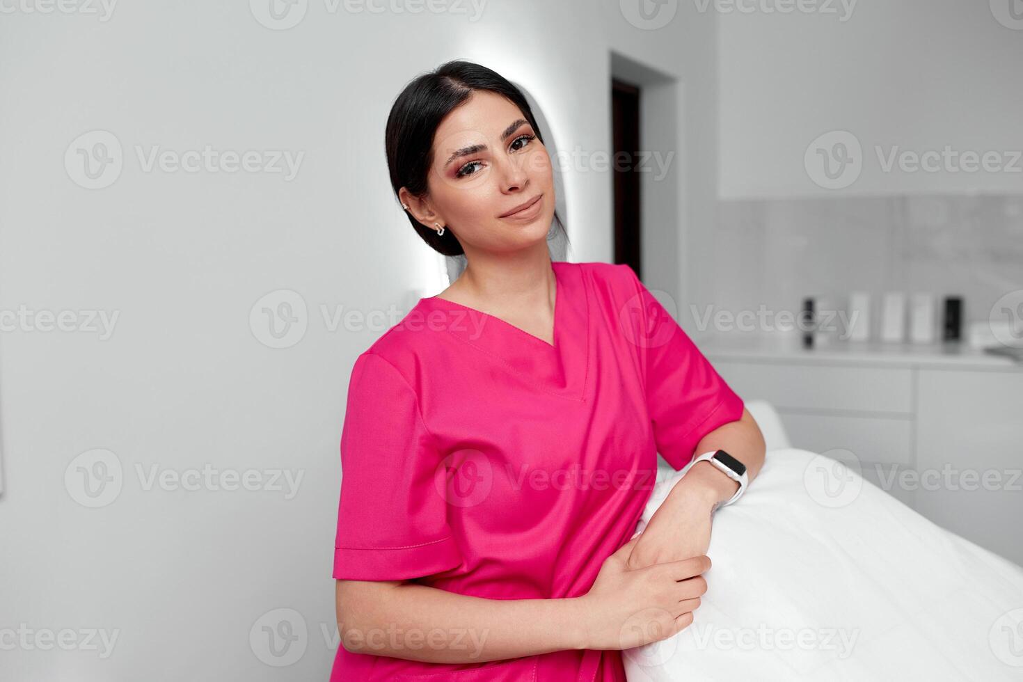 Beautiful doctor cosmetologist in a private office photo