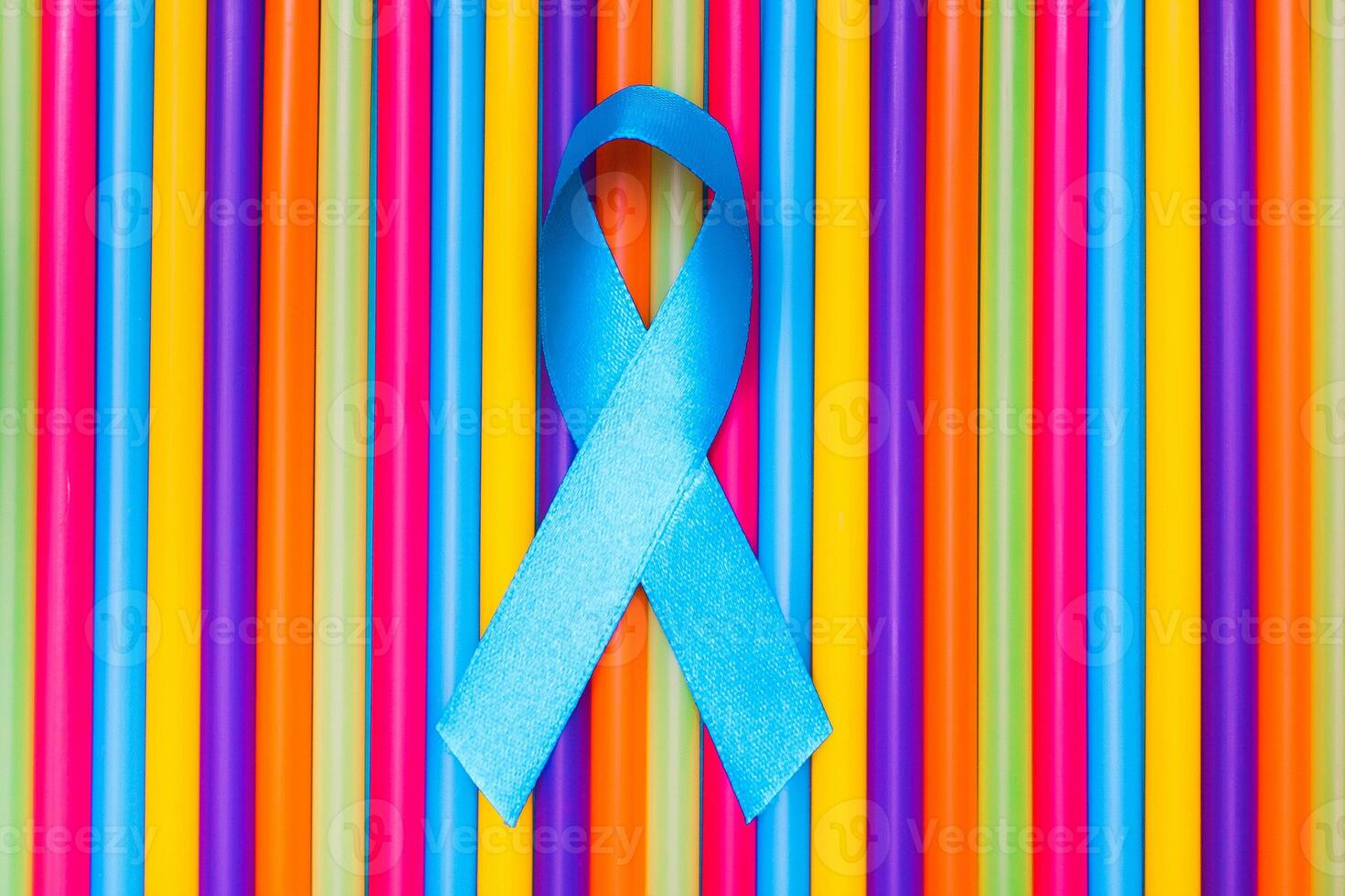 blue cancer awareness ribbon with trail on Colorful background. concept of health and medicine photo