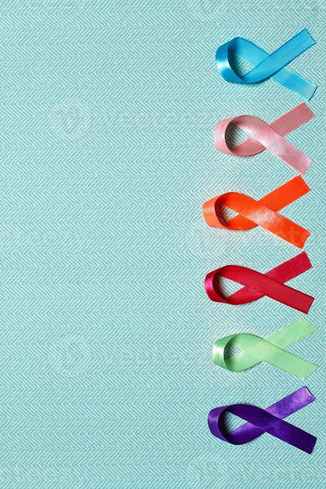 World Cancer Day. Colorful ribbons, cancer awareness, blue background. International Agency for Research on Cancer photo