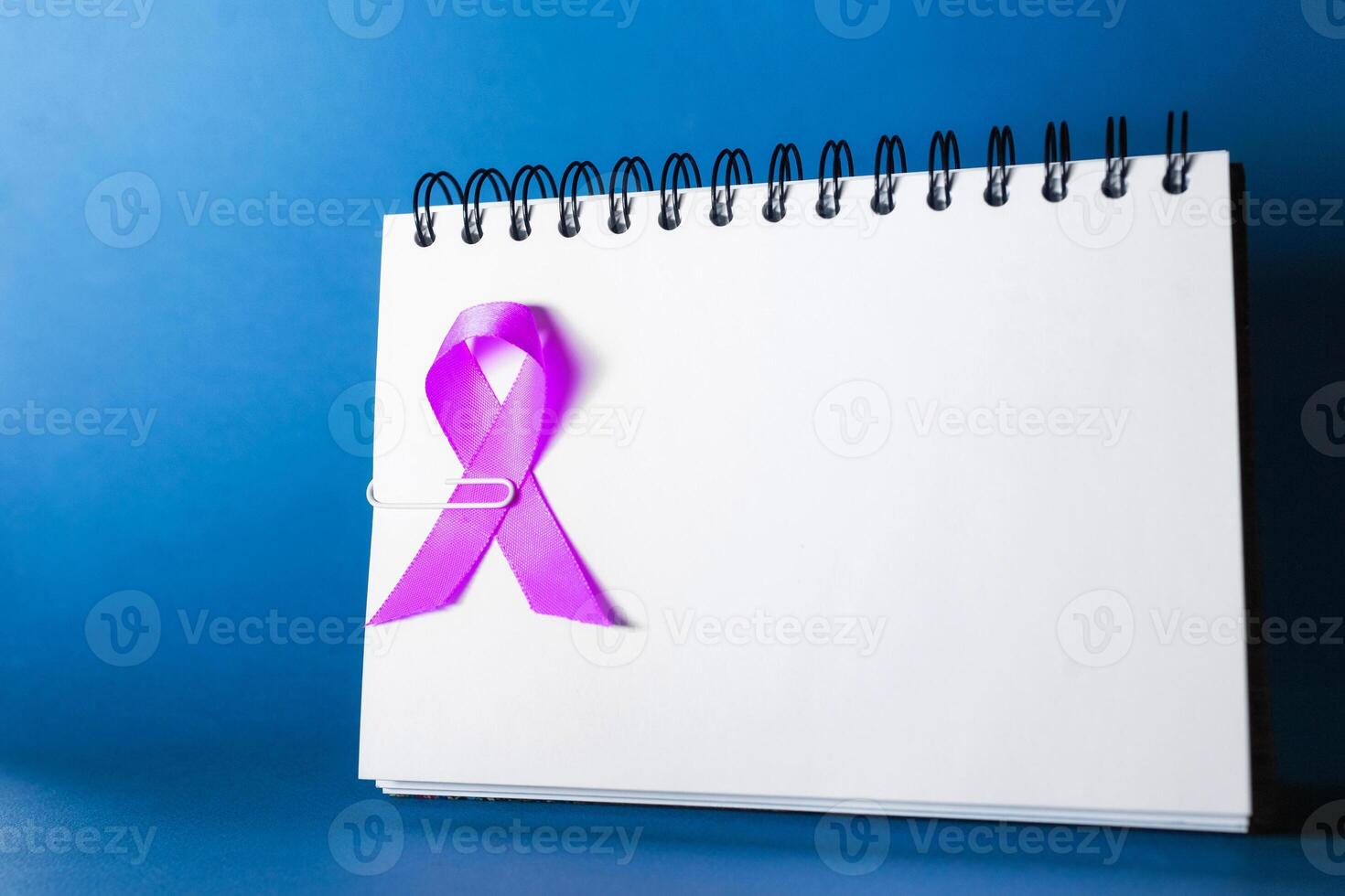 Lavender ribbon. World cancer day concept. blue background photo