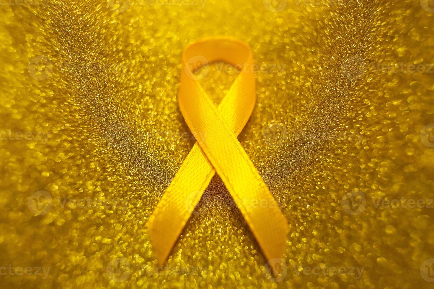 Gold ribbon for children as a symbol of childhood cancer awareness. World Cancer Day photo
