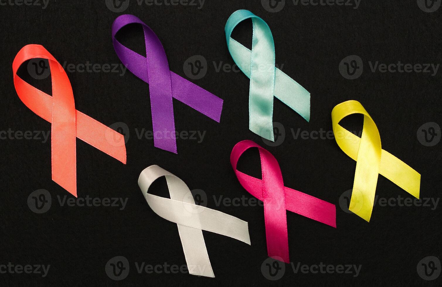 World cancer day February 4 background. Colorful ribbons, cancer awareness. black surface from above photo