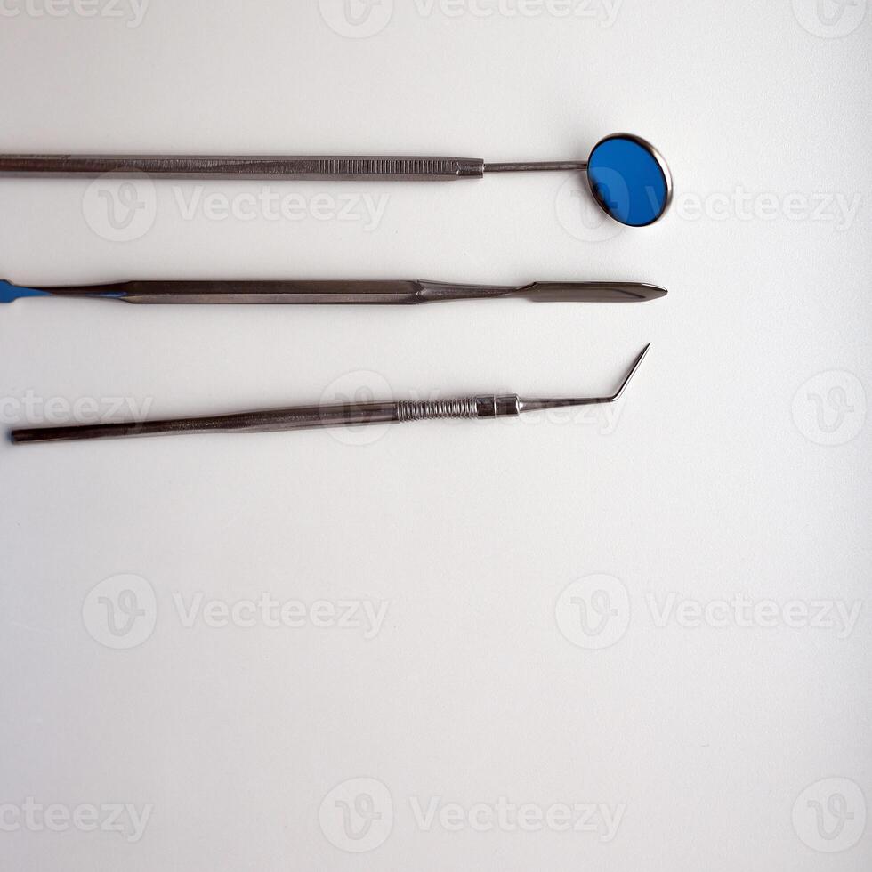 Dental tools on silver color background photo