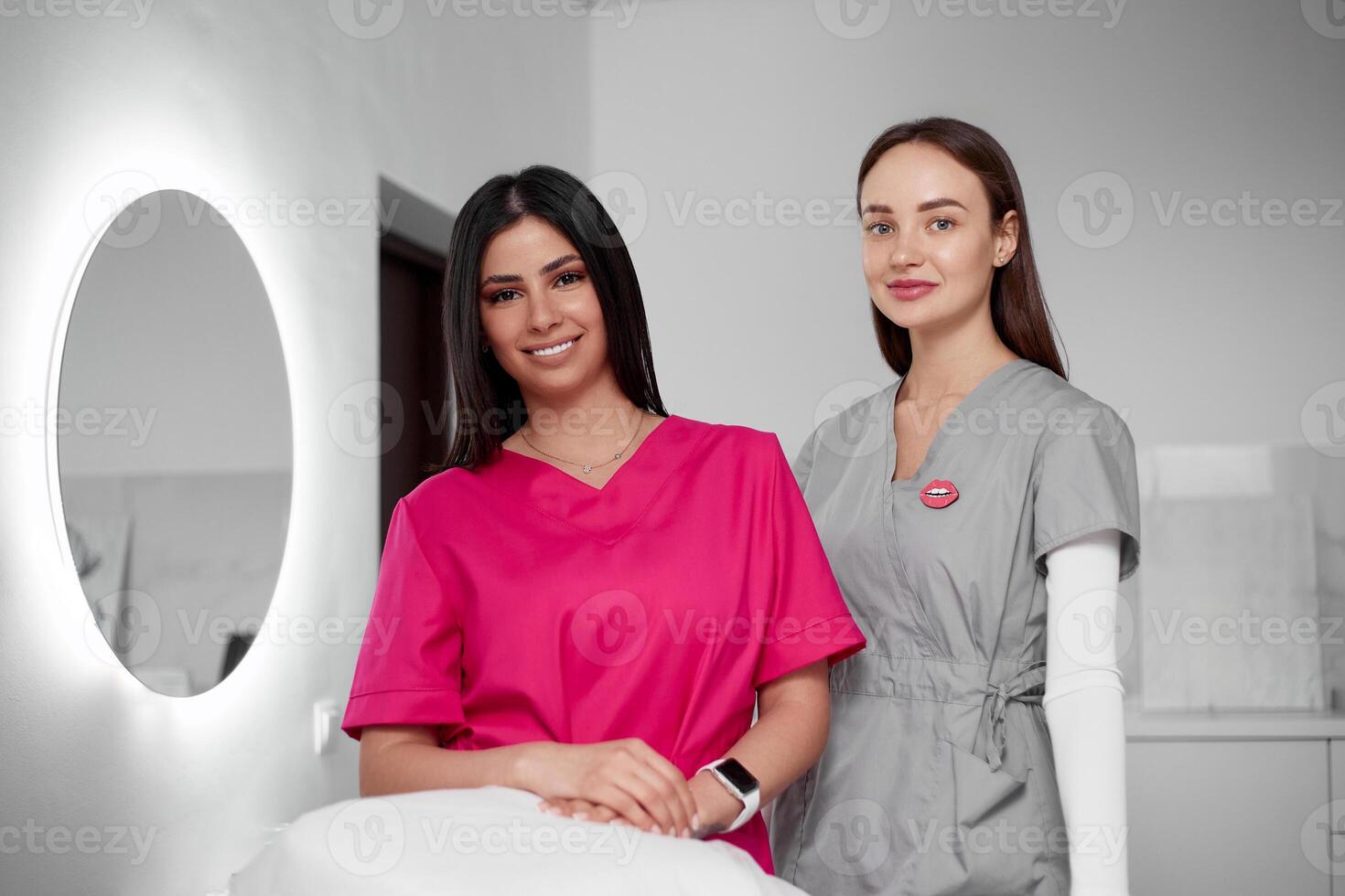 Two beautiful cosmetologist doctors in a private office photo