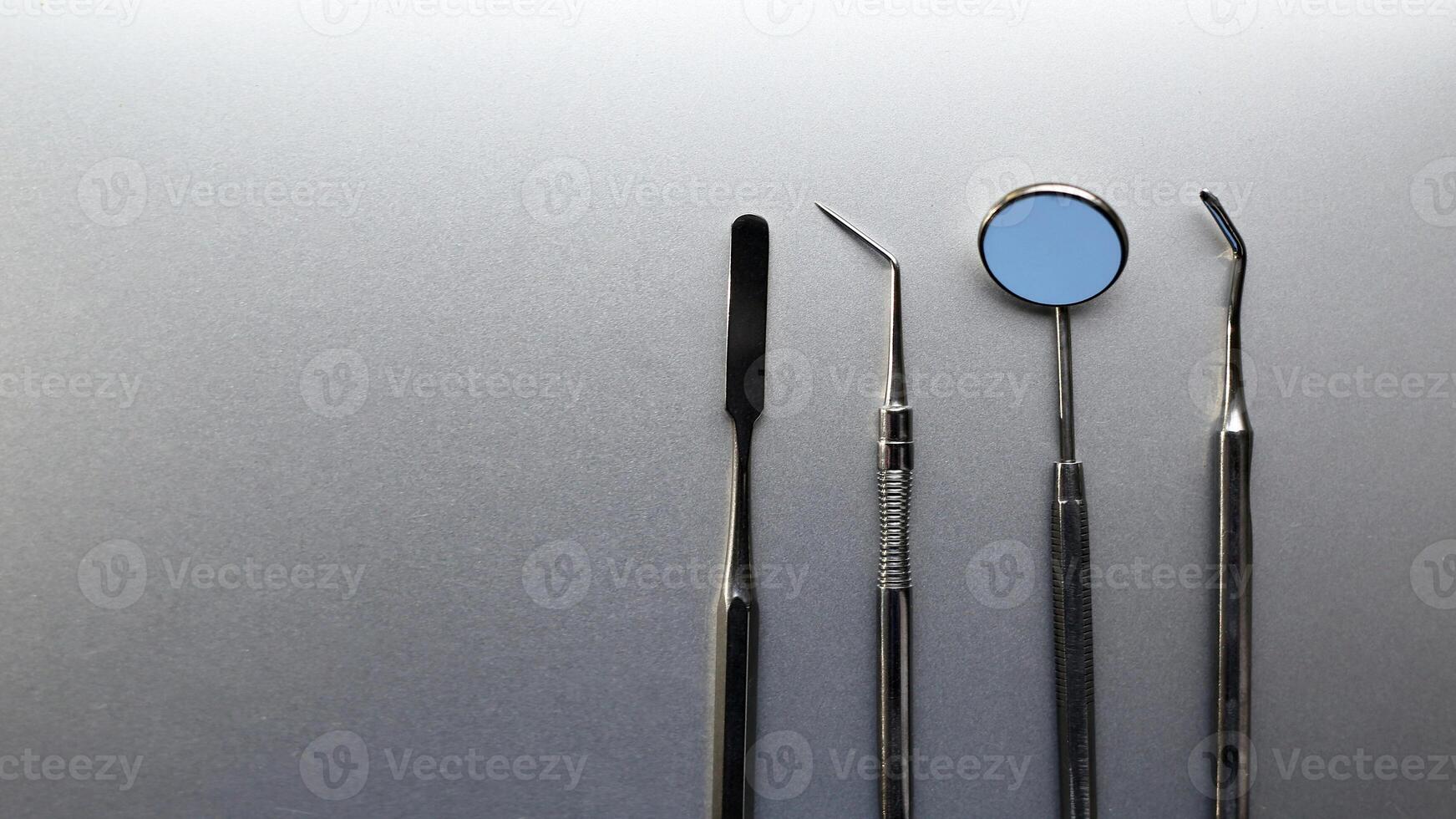 Dentist tools. Professional steel dental instruments with background with free space. photo