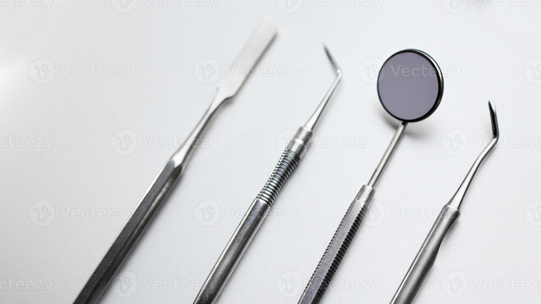 Dental tools on silver color background photo